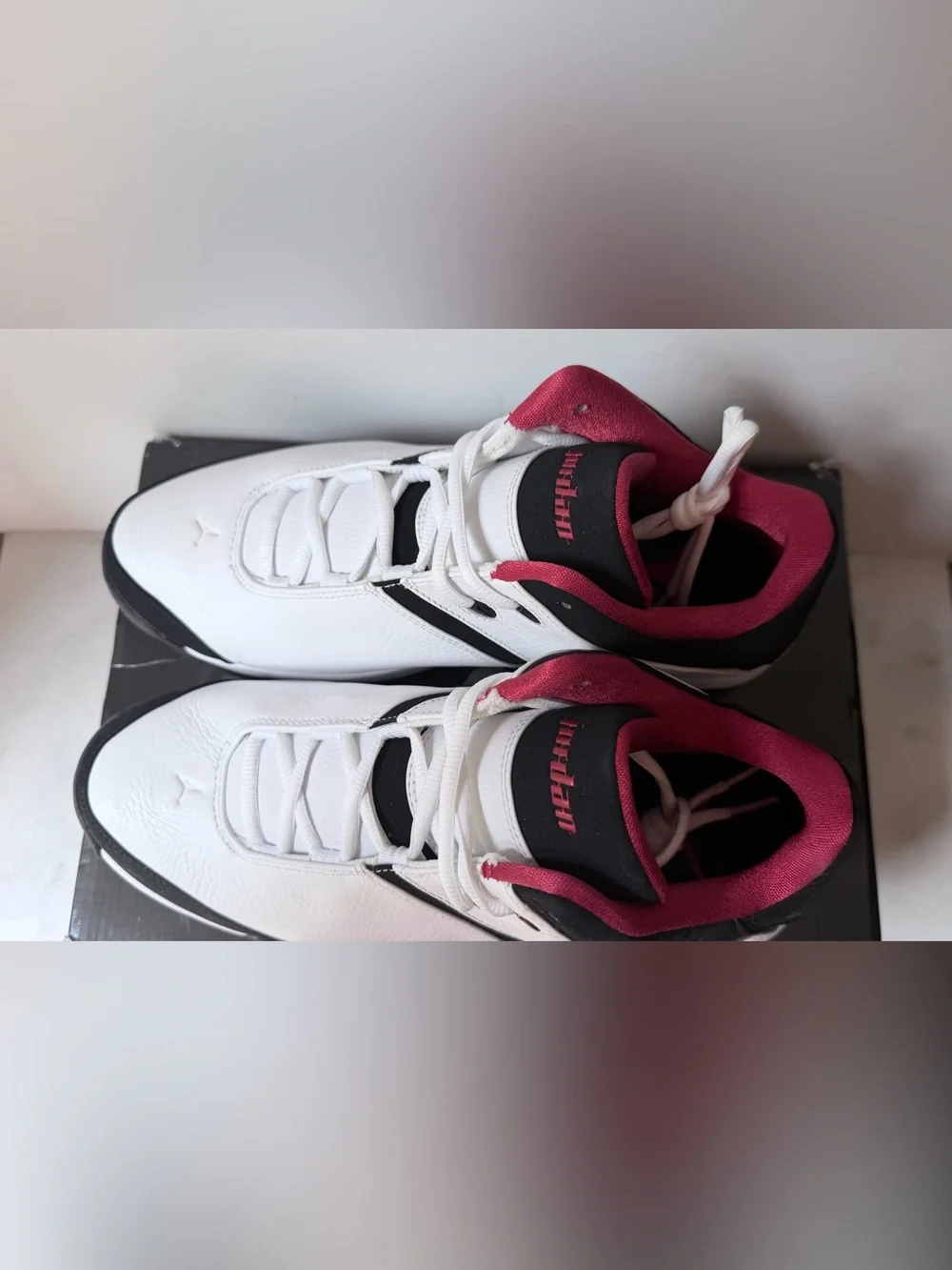 Nike Jordan Team Reign Low sneakers in a white, black, and red colorway,